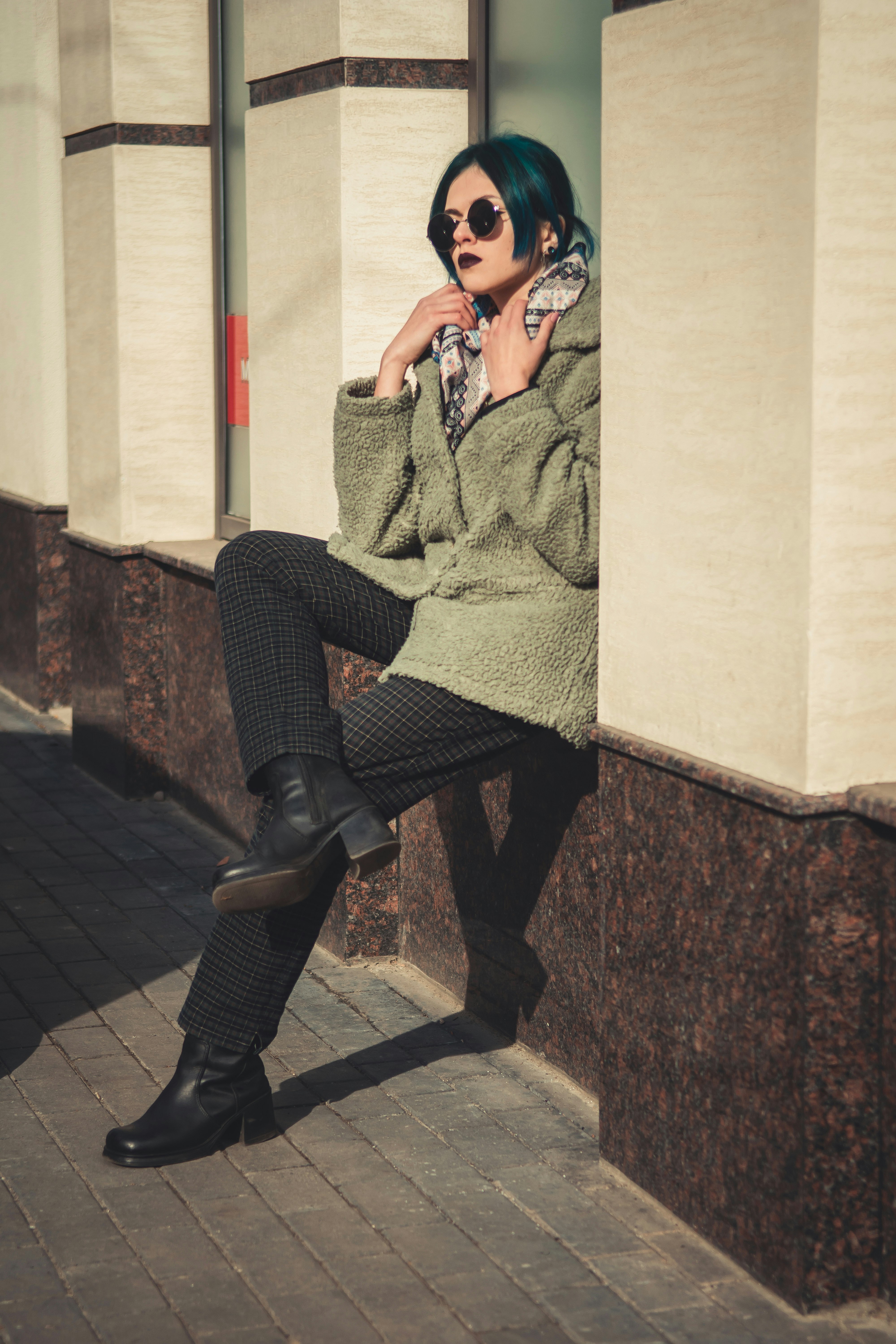 woman sitting on wall